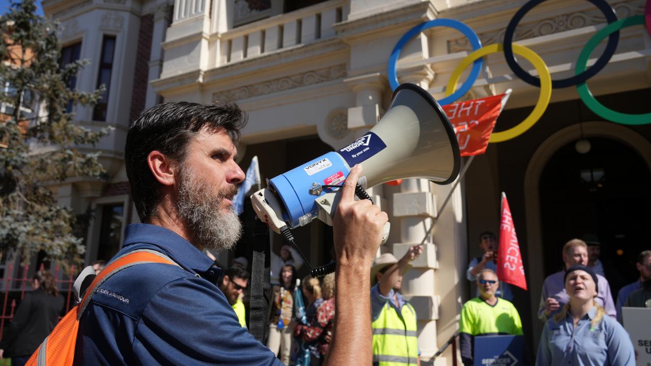 The Services Union members and indoor Toowoomba Regional Council workers hold a rally outside City Hall to protest current protracted EBA negotiations. Council worker Jay Miller leads chants with the bullhorn.