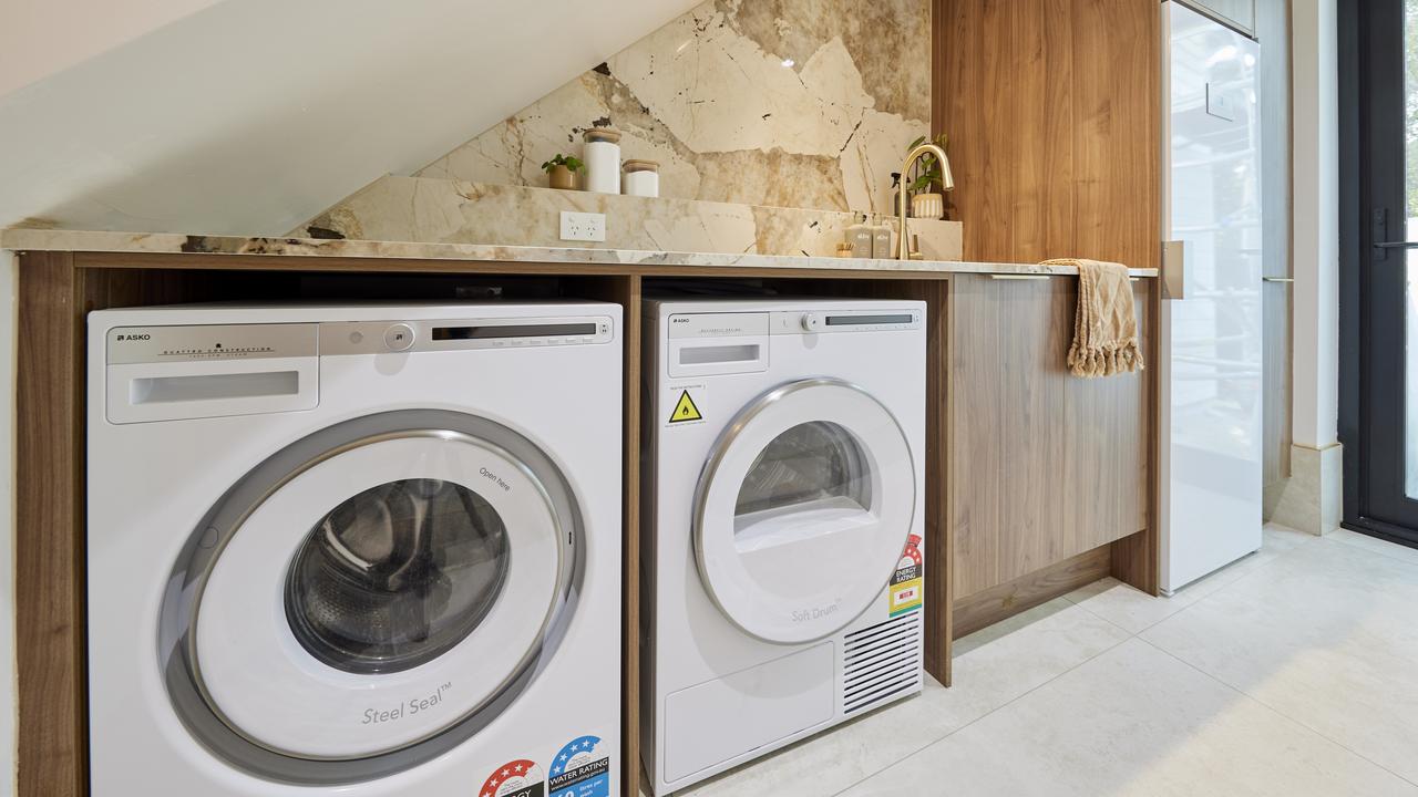 Courtney and Grant's laundry room, in a spot under the stairs guaranteed to lead to concussion.