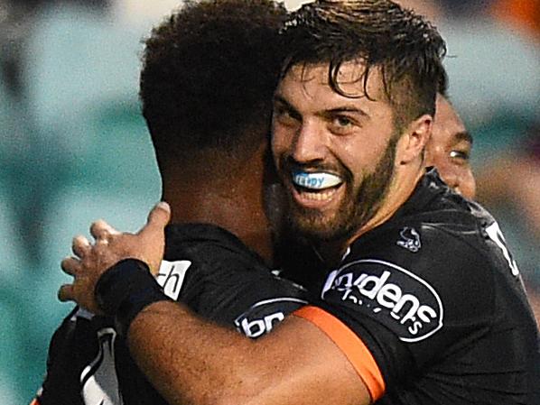 Kevin Naiqama of the Tigers is congratulated by James Tedesco after scoring a try during the round 2 NRL match between the Wests Tigers and the Manly-Warringah Sea Eagles at Leichhardt Oval in Sydney, Monday, March 14, 2016. (AAP Image/Dan Himbrechts) NO ARCHIVING, EDITORIAL USE ONLY