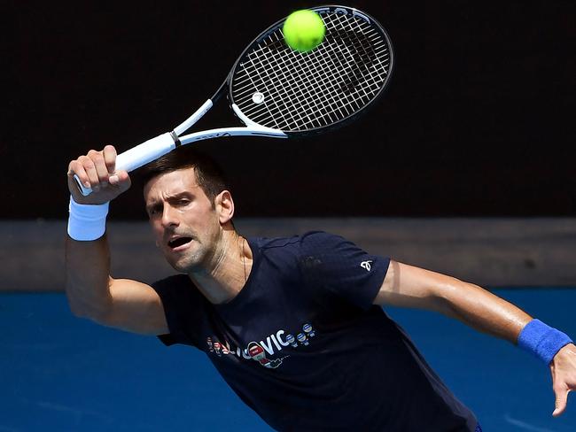 Novak Djokovic of Serbia hits a return during a practice session ahead of the Australian Open at the Melbourne Park tennis centre in Melbourne on January 12, 2022. (Photo by William WEST / AFP) / -- IMAGE RESTRICTED TO EDITORIAL USE - STRICTLY NO COMMERCIAL USE --