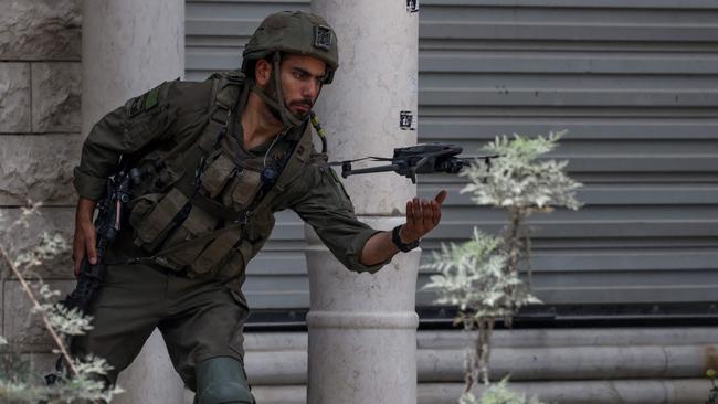 An Israeli soldier flies a drone in the occupied West Bank during a raid on April 19. Picture: AFP