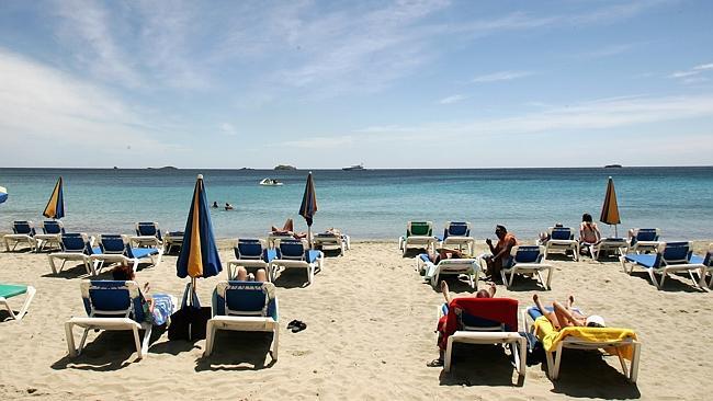 Holiday-makers soak up the sun in Ibiza, Spain.