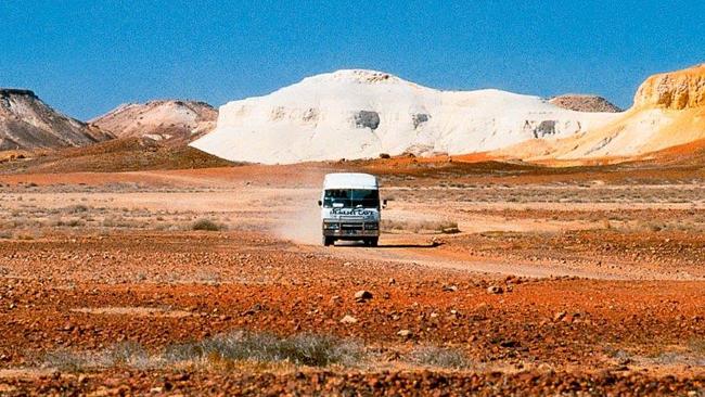 Tour bus on the road for Coober Pedy feature in Escape 21/3/15