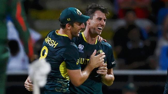 ANTIGUA, ANTIGUA AND BARBUDA - JUNE 20: Pat Cummins of Australia celebrates with teammates Mitchell Marsh and Tim David  after dismissing Taskin Ahmed of Bangladesh for his hat trick during the ICC Men's T20 Cricket World Cup West Indies & USA 2024 Super Eight match between Australia and Bangladesh at Sir Vivian Richards Stadium on June 20, 2024 in Antigua, Antigua and Barbuda. (Photo by Gareth Copley/Getty Images)