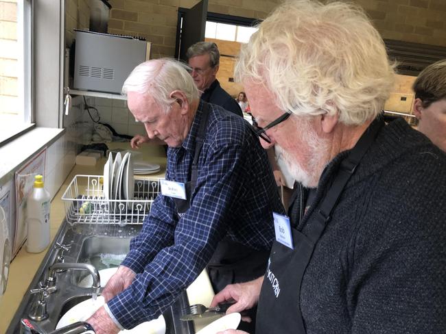 John Coye (left) and Bob Robinson help with the washing up during a Men's Kitchen Northern Beaches cooking skills session at the Forestville Community Hall on Friday. Picture: Jim O'Rourke