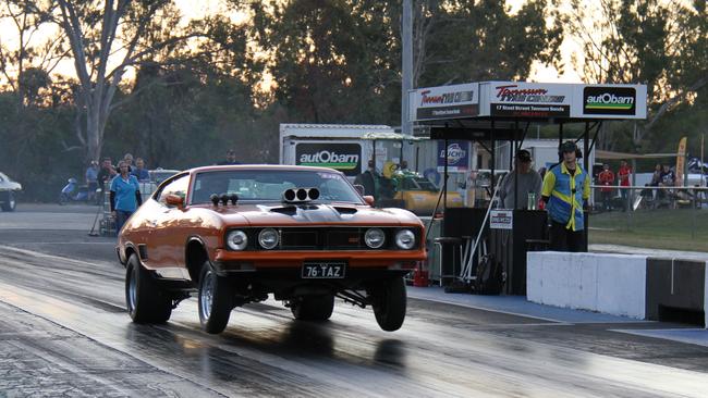 Gladstone's Brett Kelly gets the front wheels off the ground in his Ford Falcon coupe on the way to a low 10 second pass at Benaraby Dragway. Picture: Rodney Stevens