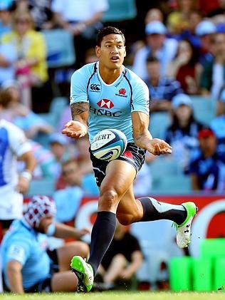 Israel Folau pops a pass for the Waratahs last year.