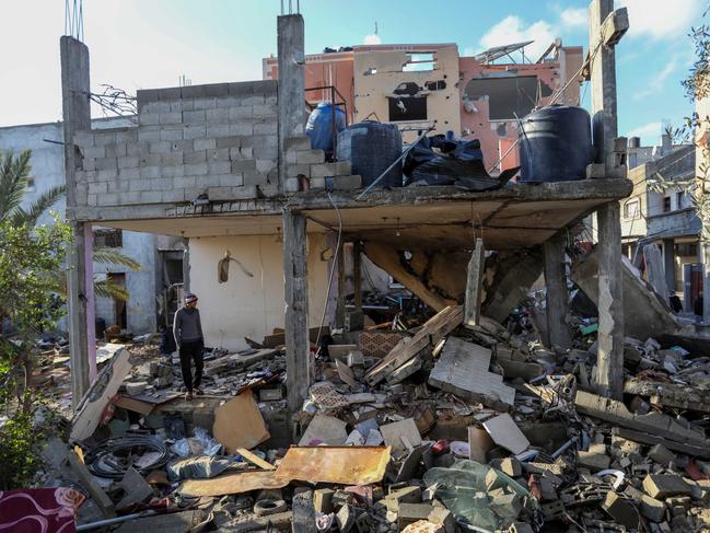 People inspect damage to their homes caused by Israeli air strikes, on January 27 in Rafah, Gaza. The death toll from the war now exceeds 25,000 dead and 62,000 injured, according to the territory's health ministry. The United Nations estimates that more than 18,000 Palestinian children have lost a parent. Picture: Ahmad Hasaballah/Getty Images