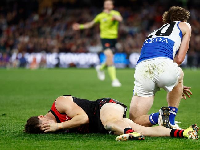 Prior holds his head after the tackle.
