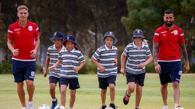 Off contract Adelaide United player Kristian Opseth (left) and Paul Izzo with students Luca Fouyaxis 10, Charlotte Zhang, 9, Nicholas Belegris, 9, and Claudia Lee, 9, at Immanuel College earlier this season.