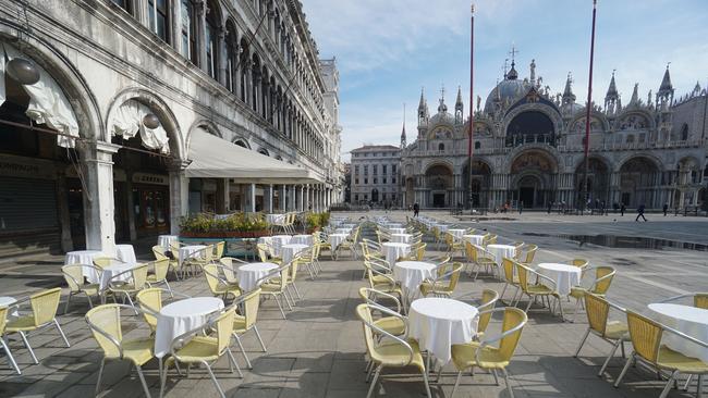 Empty chairs and tables outside a restaurant in St Mark’s Square in Venice, Italy. Picture: AP