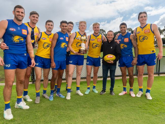 West Coast players with three-time Melbourne Cup winning jockey (and Eagles fan) Damien Oliver and the 2024 trophy at training. Picture: Jay Town