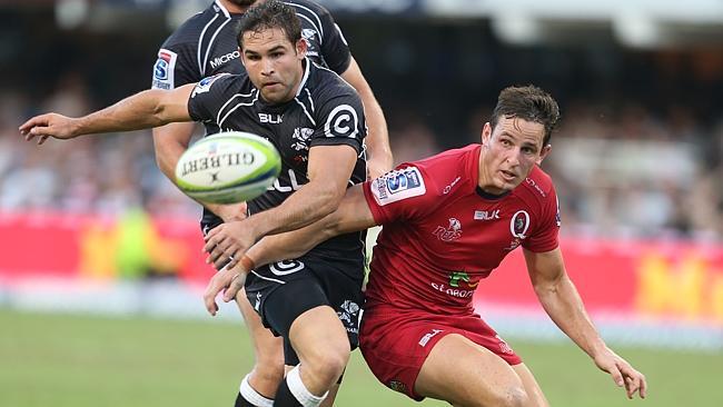 DURBAN, SOUTH AFRICA - MARCH 15: Cobus Reinach of the Cell C Sharks and Mike Harris of the Reds going for the ball during the Super Rugby match between Cell C Sharks and Reds at Growthpoint Kings Park on March 15, 2014 in Durban, South Africa. (Photo by Steve Haag/Gallo Images/Getty Images)