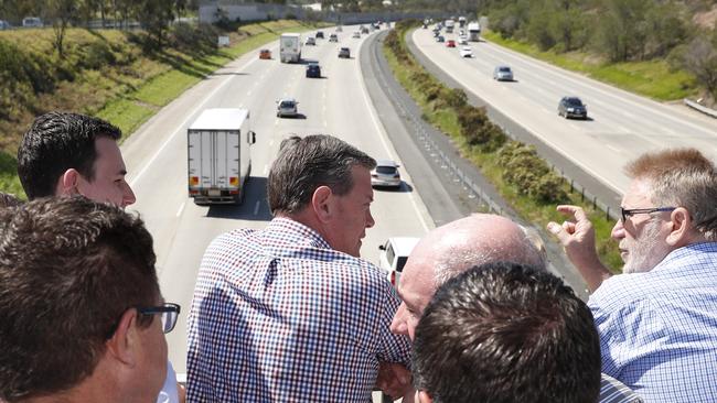 Queensland LNP leader Tim Nicholls speaks with Gold Coast candidates during a layover at Exit 45 in Ormeau. Picture: AAP Image/Regi Varghese