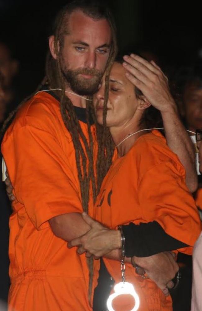 Sara Connor and David Taylor embrace while taking part in a police reenactment on Kuta beach on August 31.  Picture: Zul Eduardo