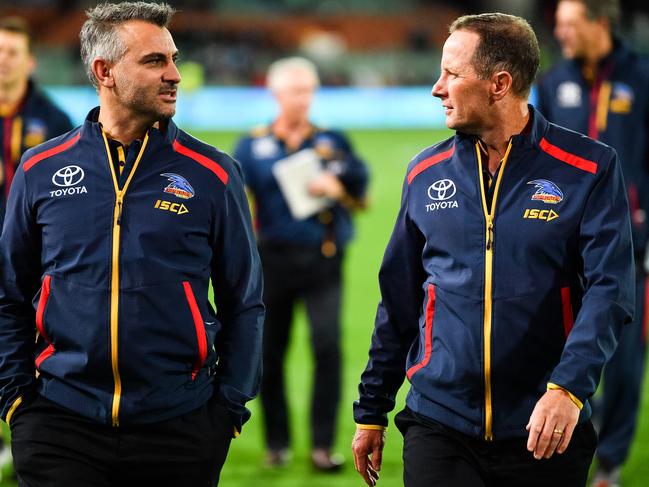 Adelaide assistant coach Scott Camporeale talks tactics with senior coach Don Pyke at a game at Adelaide Oval in May, 2019. Picture: Daniel Kalisz/Getty Images