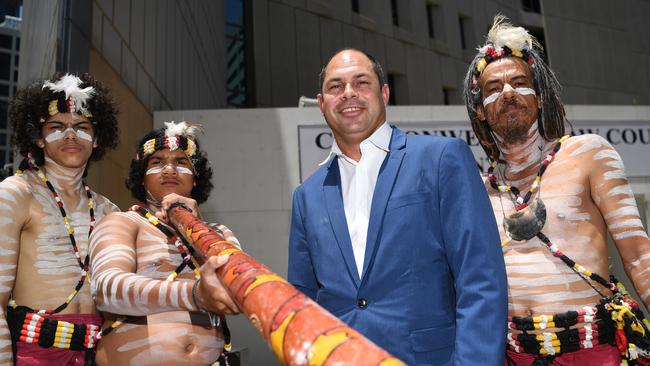 Quandamooka Yoolooburrabee Aboriginal Corporation CEO Cameron Costello with Aboriginal dancers outside the Federal Court in Brisbane in November, 2019, after the Quandamooka people were officially recognised as the traditional owners of Moreton Island. Picture: AAP Image/Dan Peled