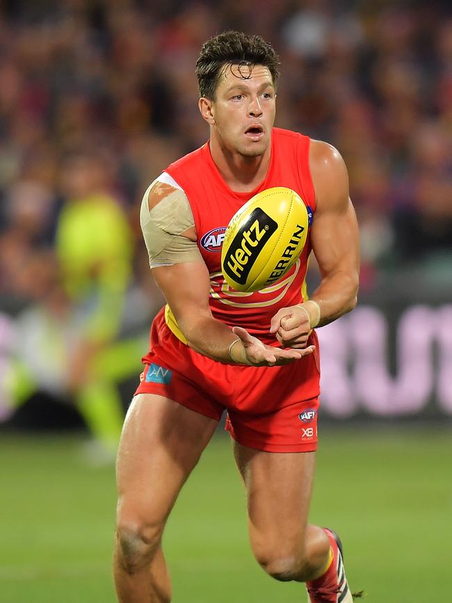 Jesse Lonergan gets a handball away for Gold Coast in match against Adelaide last year. Picture: Daniel Kalisz/Getty Images