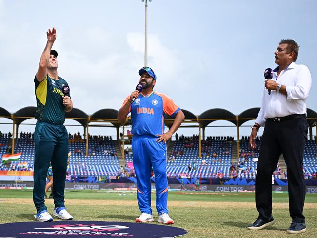 GROS ISLET, SAINT LUCIA - JUNE 24: Mitchell Marsh of Australia flips the coin as Rohit Sharma of India looks on ahead of the ICC Men's T20 Cricket World Cup West Indies & USA 2024 Super Eight match between Australia and India at Daren Sammy National Cricket Stadium on June 24, 2024 in Gros Islet, Saint Lucia. (Photo by Alex Davidson-ICC/ICC via Getty Images)