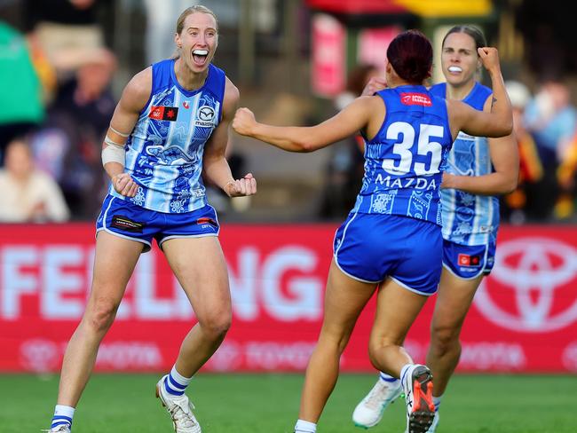 ADELAIDE, AUSTRALIA - OCTOBER 25:Kate Shierlaw of the Kangaroos .celebrates a goal with Jenna Bruton during the 2024 AFLW Round 09 match between Kuwarna (Adelaide Crows) and the North Melbourne Tasmanian Kangaroos at Norwood Oval on October 25, 2024 in Adelaide, Australia. (Photo by Sarah Reed/AFL Photos via Getty Images)