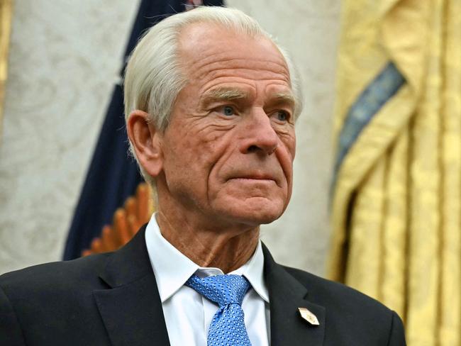 Counselor to US President Donald Trump, Peter Navarro listens to unseen US President Donald Trump speak to the press after signing an executive order, in the Oval Office of the White House in Washington, DC, on February 10, 2025. (Photo by ANDREW CABALLERO-REYNOLDS / AFP)