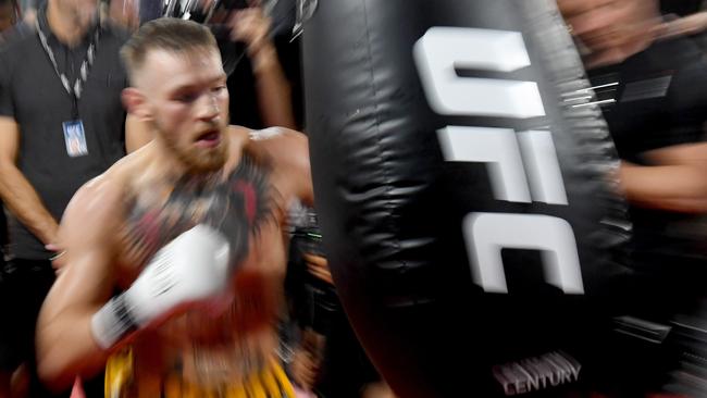 Conor McGregor hits a heavy bag during a media workout.