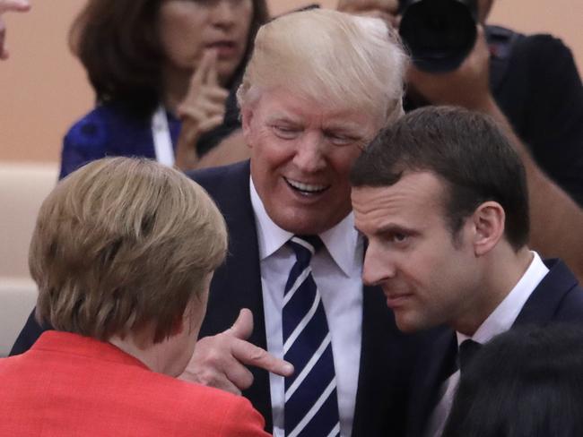 Donald Trump chats amiably with the German and French leaders backstage. Picture: Photo/Markus Schreiber