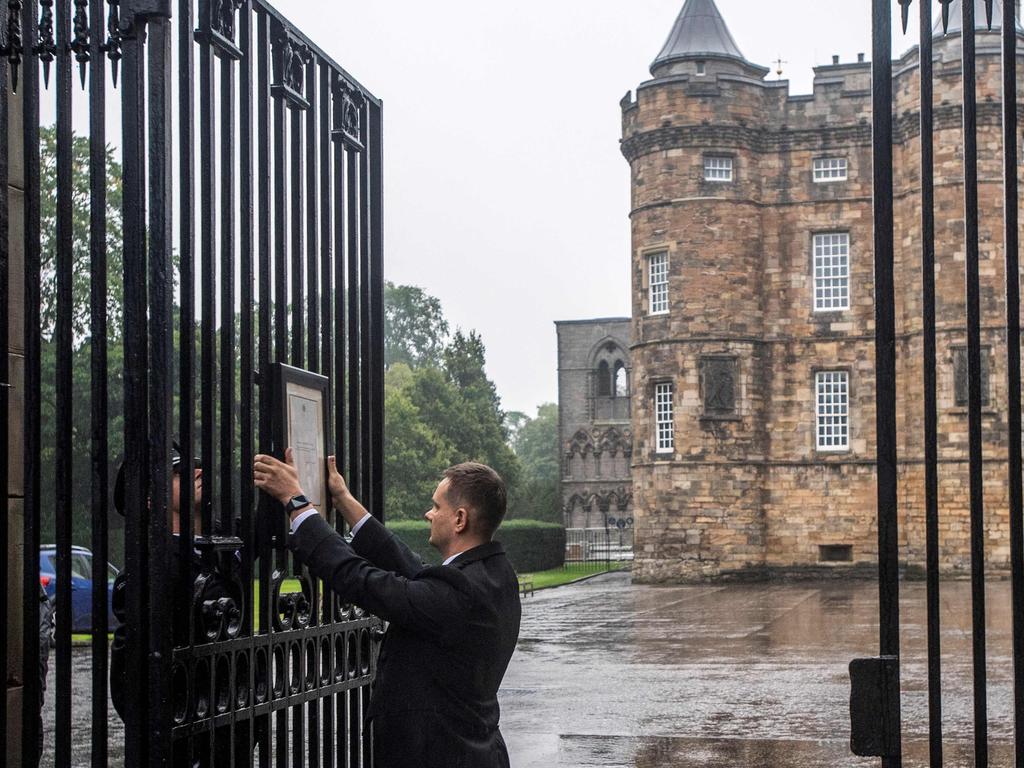 A notice is placed on the gates of the Palace of Holyroodhouse in Edinburgh, where the Queen’s body will rest today. Picture: Lesley Martin/AFP