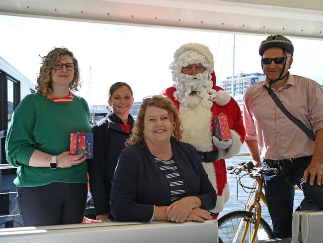 Hobart Lord Mayor Anna Reynolds with Children's Mayor Lola Mennitz, commuters Naomi Duke and Christian Narkowicz, and Santa on the ferry at Brooke Street Pier. Picture: John Sampson