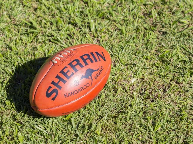 "Lismore, NSW, Australia - May 9, 2012: A Kangaroo Brand Sherrin football sits on grass. This is the official ball of AFL, Australian Rules Football, and has been used since the 1880s"