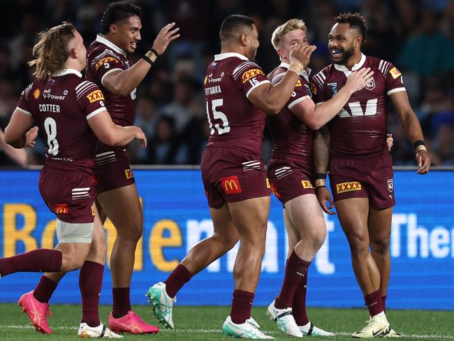 Hamiso Tabuai-Fidow celebrates scoring a try with his Maroons teammates. Picture: Getty Images