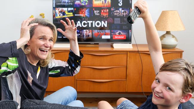 Claire Rosel and son Clancy compare new data on Aussie TV viewing habits which reveals just how much time we waste scrolling. Picture: Brendan Beckett