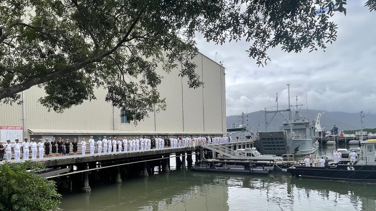The servicemen and women of HMAS Cairns line the wharf to salute outgoing Commanding Officer Alfonso Santos. Photo: Dylan Nicholson
