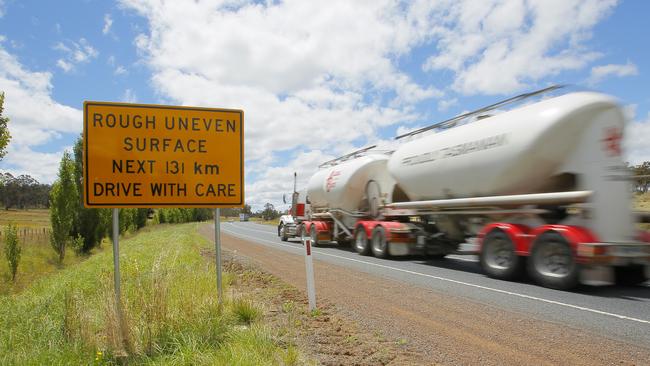 A traffic road sign on the Midland Highway that someone has modified to read rough uneven surface for 131 kilometres, but should read 3kms