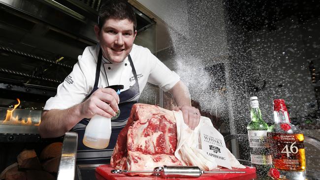 Simon Street, Executive Chef at the Regatta Hotel injecting whisky into Thousand Guineas Bone-in Sirloin, Brisbane 28th of September 2020. (Image/Josh Woning)