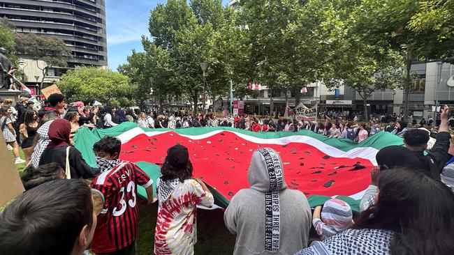 Victorian protesters unfurl a watermelon flag to represent the colours of Palestine. Picture: Suzan Delibasic