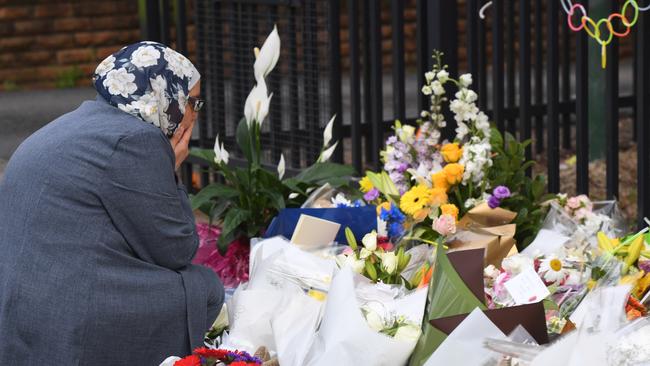 Mourners place flowers outside Banksia Road Public School in Greenacre, in Sydney’s south west, where two 8-year-old boys died after a car ploughed through their classroom. Picture: AAP