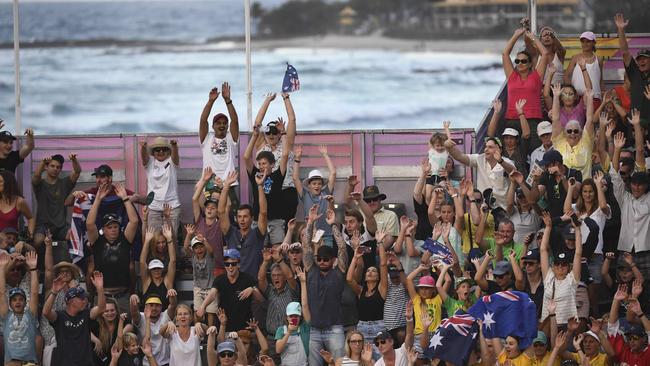 Australian fans cheer on their team during the gold medal match between Australia and Canada in the men's beach volleyball at the 2018 Gold Coast Commonwealth Games on April 12, 2018. / AFP PHOTO / WILLIAM WEST