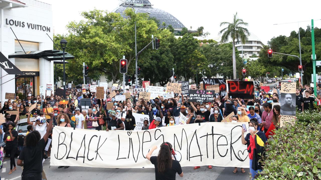 Thousands march through the Cairns CBD chanting and waving placards to protest black deaths in custody and support the Black Lives Matter movement. Picture: PETER CARRUTHERS