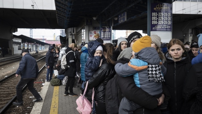 People flock to a train station to flee the city after Russia announced a temporary ceasefire. Picture: Getty