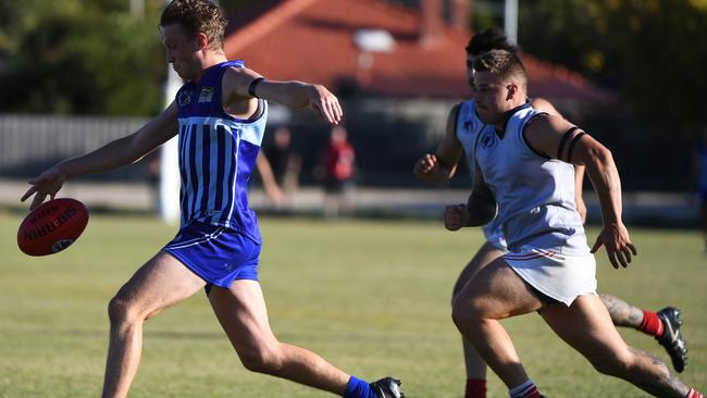 Reservoir’s Josh Alexander is pursued by two Lalor opponents. Picture: James Ross.