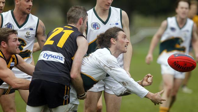 Joel Donaldson fires a handball out during Northcote Park’s Round 9 clash with Whittlesea. Picture: Richard Serong.