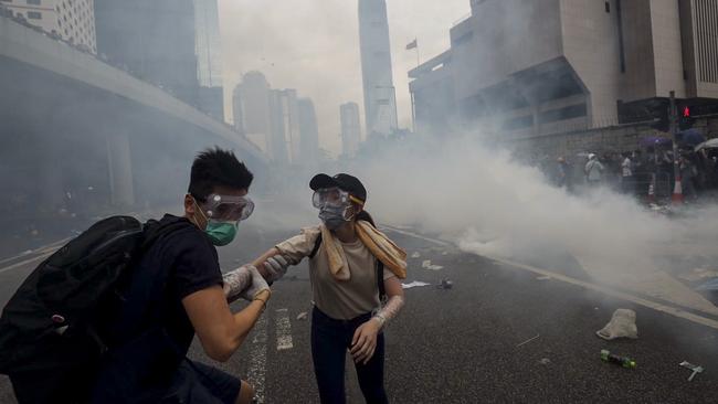 Protesters leave the area after police fired tear gas. Picture: Sam Pang