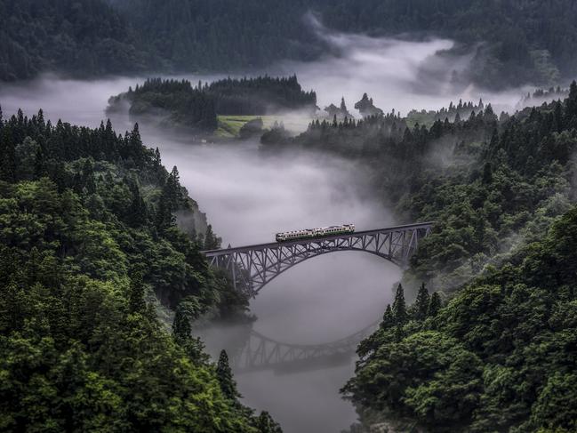 Photo by TERUO ARAYA / National Geographic Nature Photographer of the Year contest Tadami Line Tadami line is a JR East line that connects Fukushima pref and Niigata pref. It is a single-track, non-electrified local line. This line runs through the serene countryside where people live closely to the nature in satoyama, the border area between mountain foothills and flat land. Especially along the Tadami River, the view from the train is stunning. The train goes over a number of bridges passing cherry blossoms in spring, greenery in summer, colored leaves in autumn, and snow in winter.