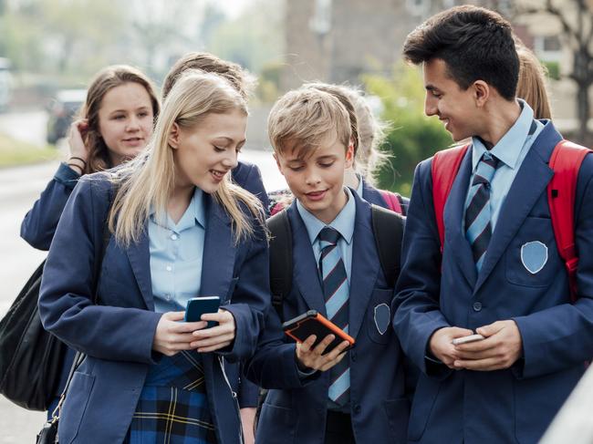 Group of teenage students walking home from school together.