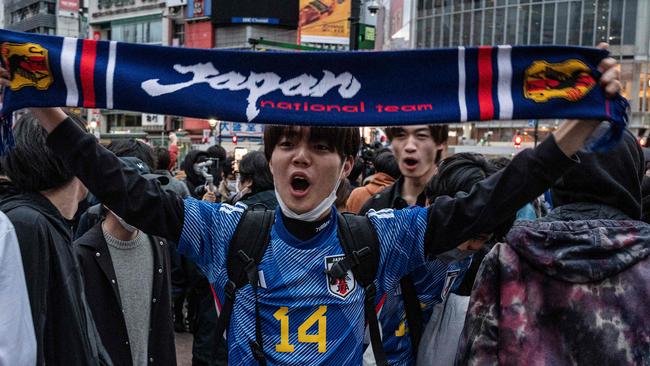 Fans celebrate after Japan's victory over Spain, at the Shibuya Crossing area in Tokyo. Picture: AFP