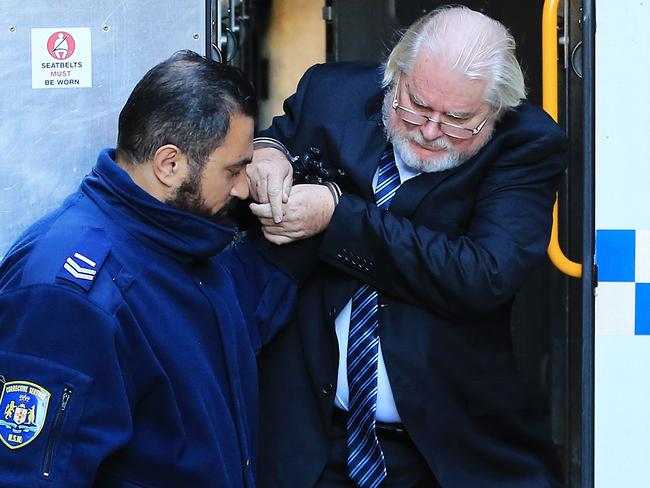 GP Brian Crickitt is led from a police van into court this morning to hear his fate. Picture: Jenny Evans.