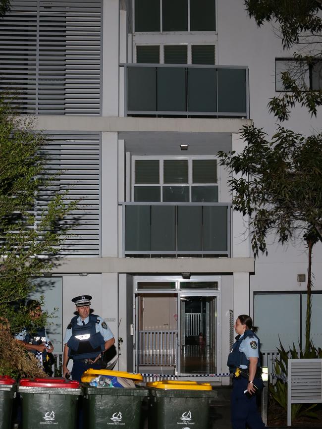 Officers outside the unit block. Picture: Bill Hearne