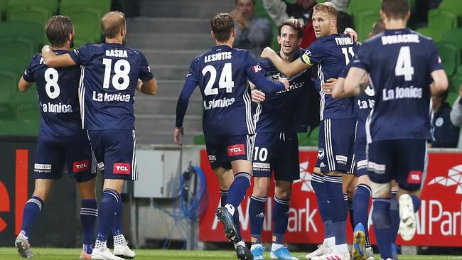 Melbourne Victory’s Robbie Kruse, fourth from left, is congratulated by teammates after scoring against Perth Glory at AAMI Park. Picture: Getty Images