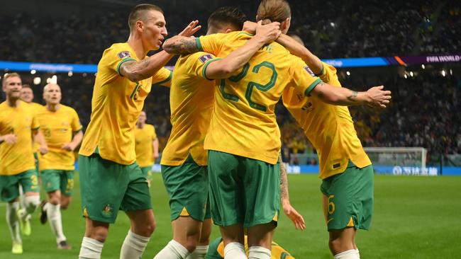 Australian players celebrate Craig Goodwin’s opener.